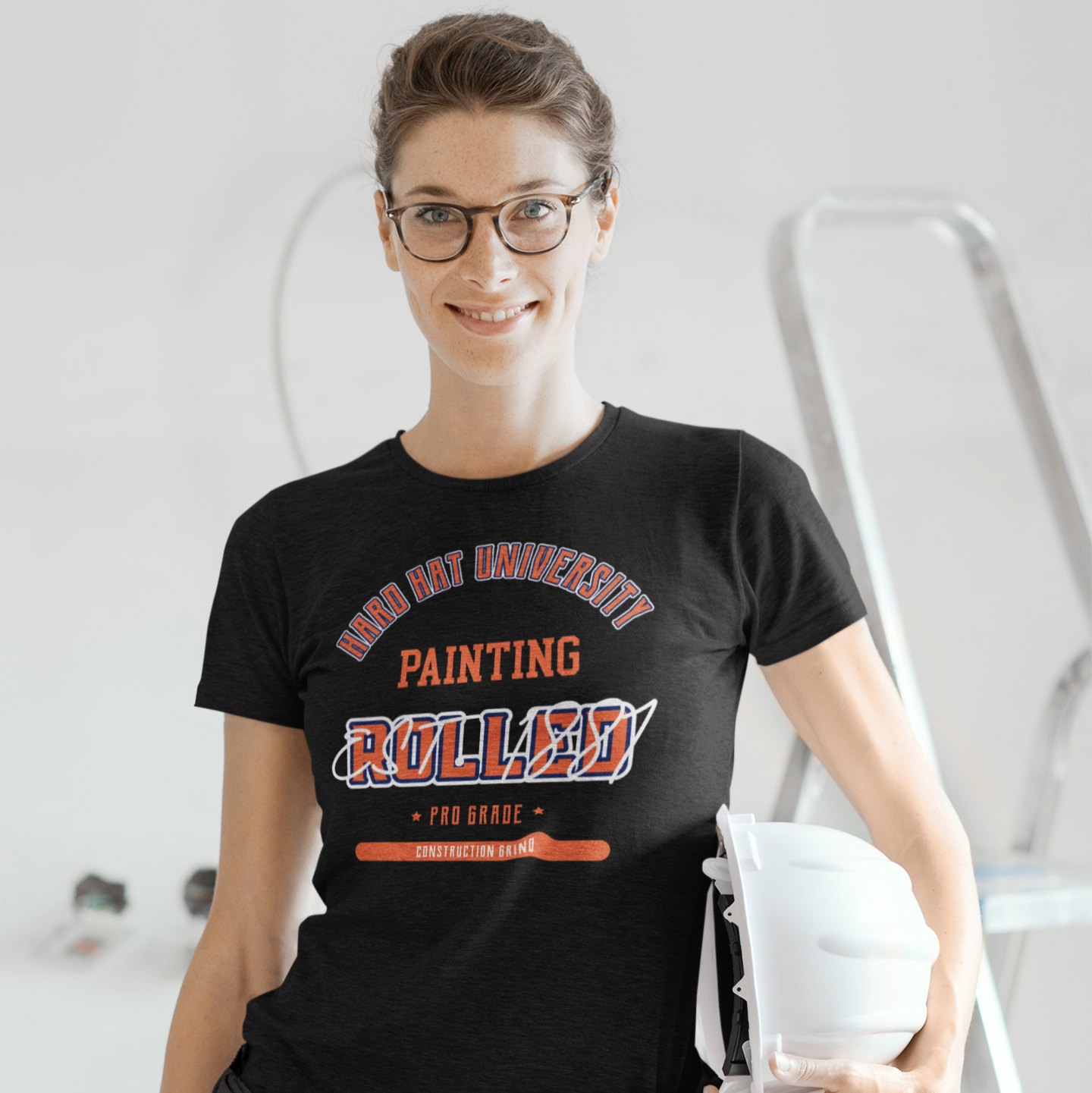 The Construction Grind “Hard Hat University” Painter's Trade T-Shirt features 'Painting – Rolled' in bold college sports style lettering, paying tribute to the skill & professionalism that builds our world. The “Established” date represents the year the trade was formally recognized in the U.S. The 'PRO-GRADE' stamp adds a touch of authenticity and pride. Design is featured on a black Gildan 5000 short-sleeved T-Shirt made with 100% U.S. cotton. Heavy Cotton 5.3 oz/y.