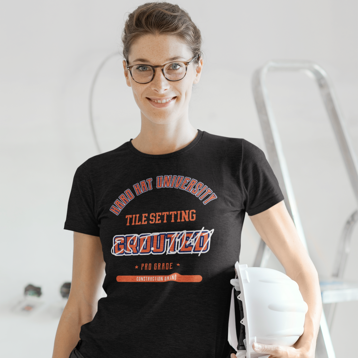 The Construction Grind “Hard Hat University” Tile Setter's Trade T-Shirt features 'Tile Setting – Grouted' in bold college sports style lettering, paying tribute to the skill & professionalism that builds our world. The “Established” date represents the year the trade was formally recognized in the U.S. The 'PRO-GRADE' stamp adds a touch of authenticity and pride. Design is featured on a black Gildan 5000 short-sleeved T-Shirt made with 100% U.S. cotton. Heavy Cotton 5.3 oz/y.