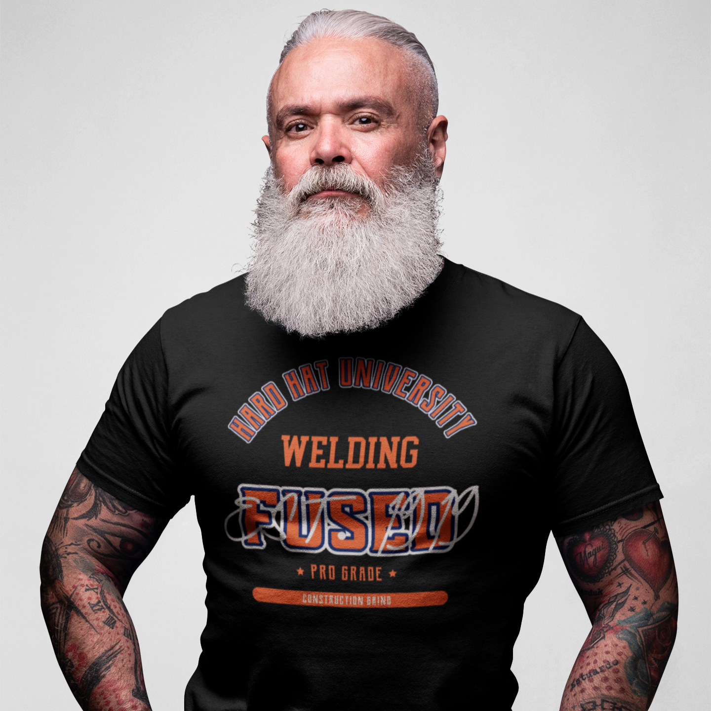 The Construction Grind “Hard Hat University” Welder's Trade T-Shirt features 'Welding – Fused' in bold college sports style lettering, paying tribute to the skill & professionalism that builds our world. The “Established” date represents the year the trade was formally recognized in the U.S. The 'PRO-GRADE' stamp adds a touch of authenticity and pride. Design is featured on a black Gildan 5000 short-sleeved T-Shirt made with 100% U.S. cotton. Heavy Cotton 5.3 oz/y.