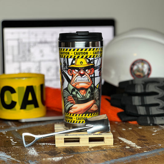 Construction Grind's "Meet the Crew" First Shift 12 oz. coffee tumbler sitting on a 4" wooden pallet coaster. Showing a close-up of our General Superintendent, "Ralph", one of three crew members shown on the tumbler.