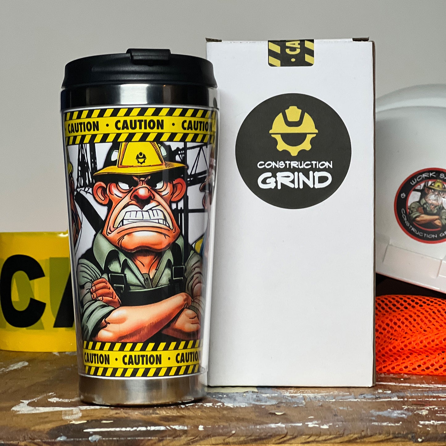 The "Meet the Crew" First Shift 12 oz. coffee tumbler comes in a white gift box with the Construction Grind logo and a caution tape sticker box seal.