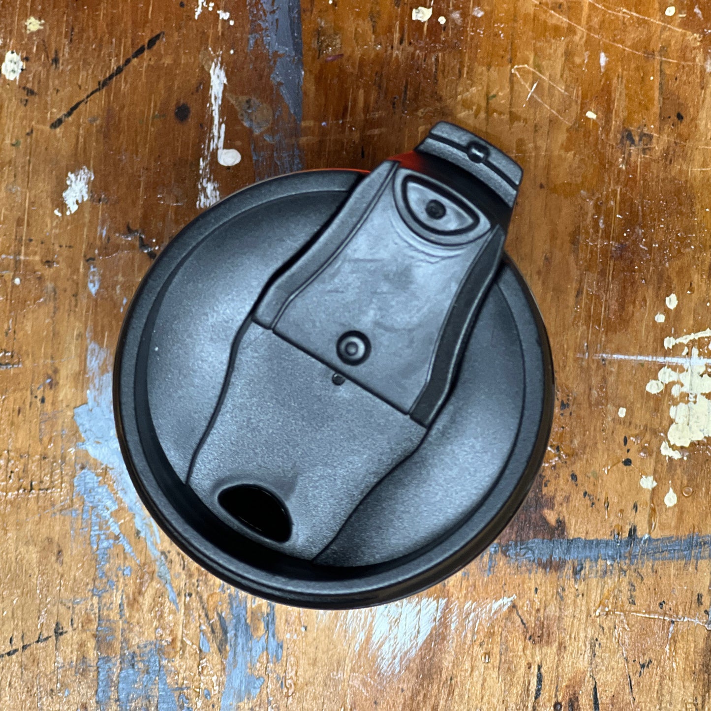 Showing the coffee tumbler's flip-top lid in the open position.