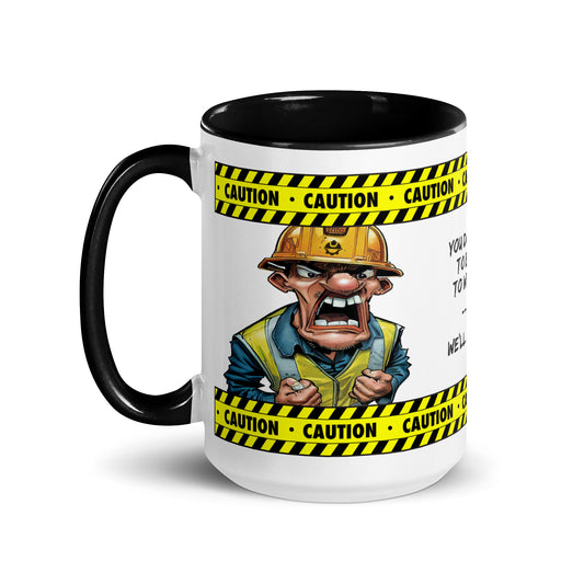 Left side of the "You Don't Have To Be Crazy To Work Here. We'll Train You." 15 oz. white ceramic mug by Construction Grind, with black accent interior and handle, featuring our crazy  looking Construction Foreman and yellow and black caution tape graphic, winding around the top and bottom of the mug.