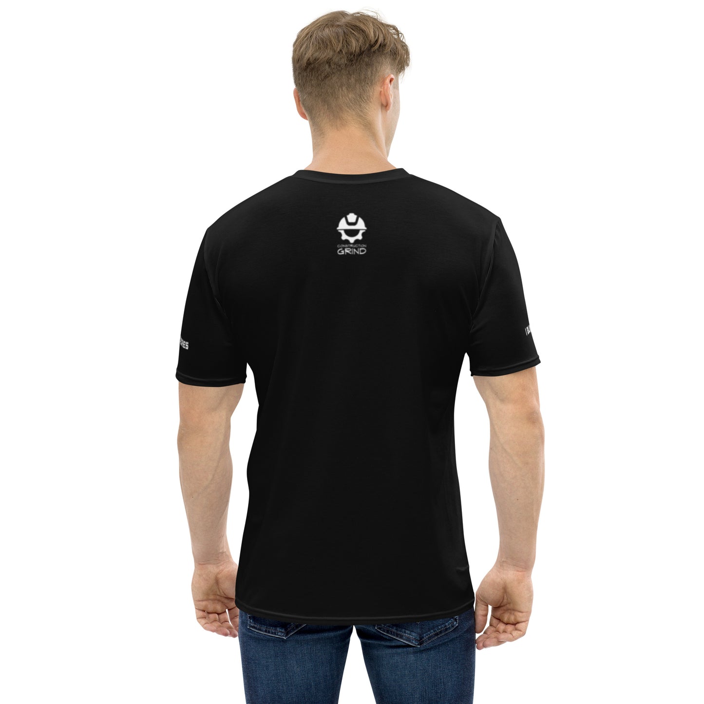 A man wearing our all-over print short-sleeved t-shirt, shown from the back. The back features the Construction Grind logo printed in crisp white against a black background, emphasizing the premium all-over print design with dynamic construction site imagery.