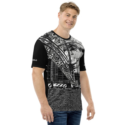 A man wearing our Construction Grind Heavy Lift all-over print short-sleeved t-shirt in black and white style, shown from the right-hand view. The image reveals the detailed main graphic of a large crane in action on a construction site, and the right sleeve displays a white 'I Build' graphic. The design emphasizes bold construction imagery on a premium tee.