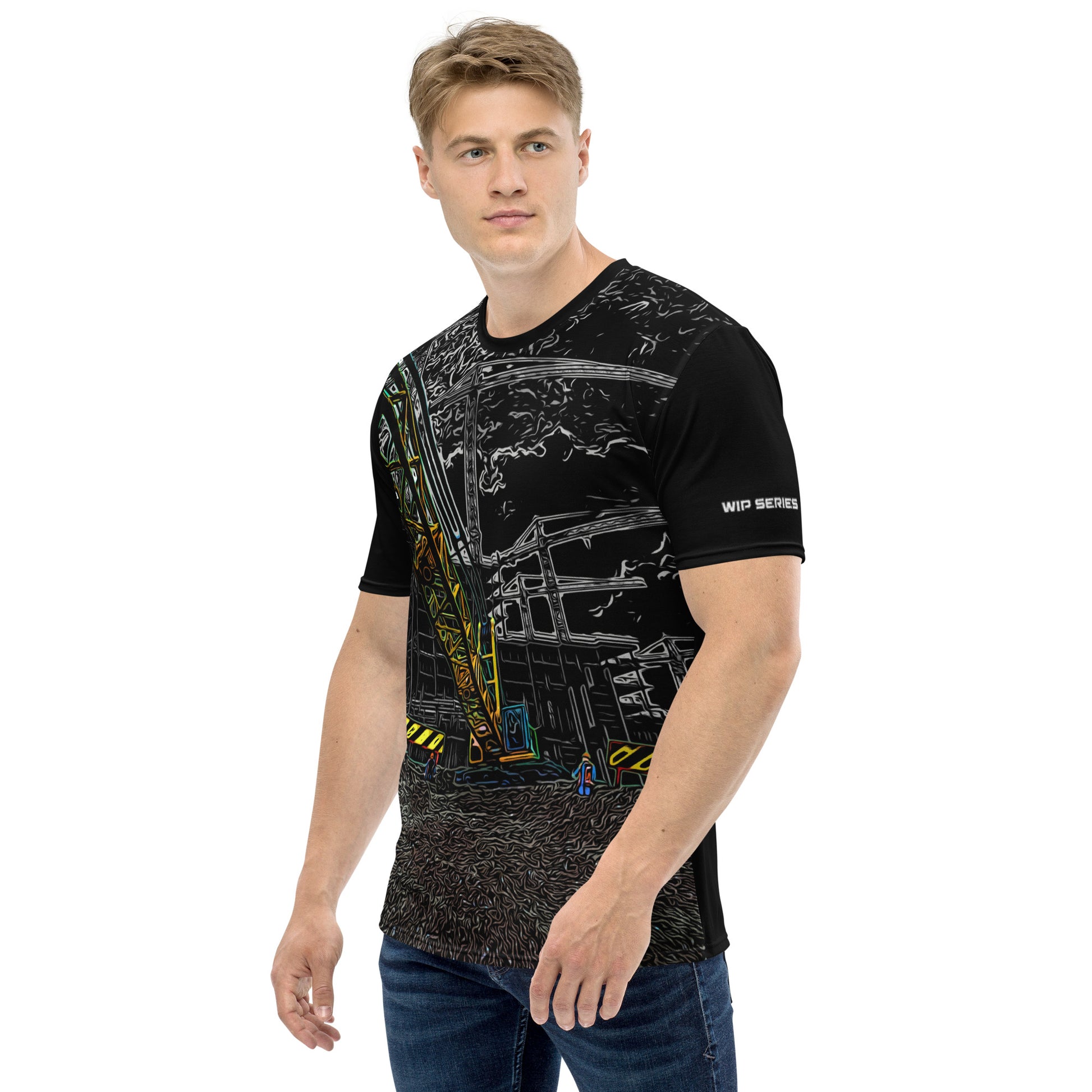 A man our wearing Construction Grind Heavy Lift all-over print short-sleeved t-shirt in night shift style, shown from the left-hand view. The image reveals the detailed main graphic of a large crane in action on a construction site, and the left sleeve displays a white 'WIP SERIES' graphic. The design emphasizes bold construction imagery on a premium tee.