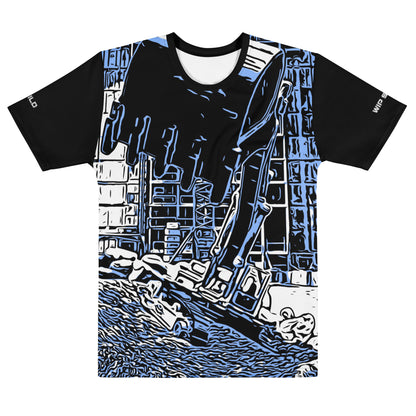 Our Construction Grind Super Scooper all-over print short-sleeved t-shirt in our blue jeans style, shown from the front. The main graphic features a large excavator with the shovel front and center, digging at a construction site in front of a building under construction, highlighting dynamic construction imagery. The design is printed in vibrant colors on a premium, all-over print tee.