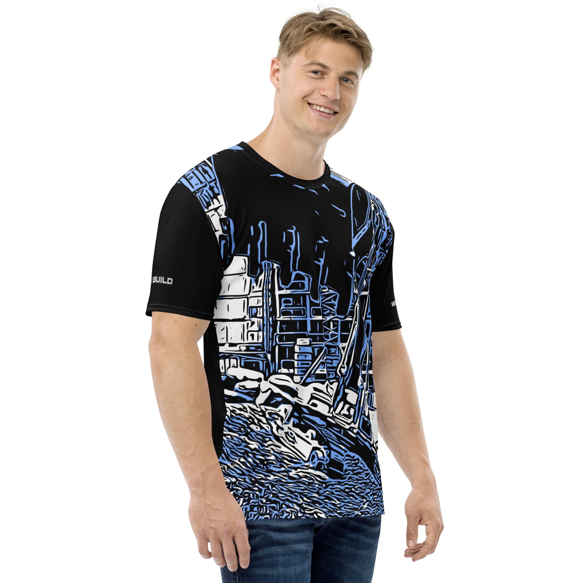 A man wearing our Construction Grind Super Scooper all-over print short-sleeved t-shirt in blue jeans style, shown from the right-hand view. The image reveals the detailed main graphic of an excavator in action on a construction site, and the right sleeve displays a white 'I Build' graphic. The design emphasizes bold construction imagery on a premium tee.