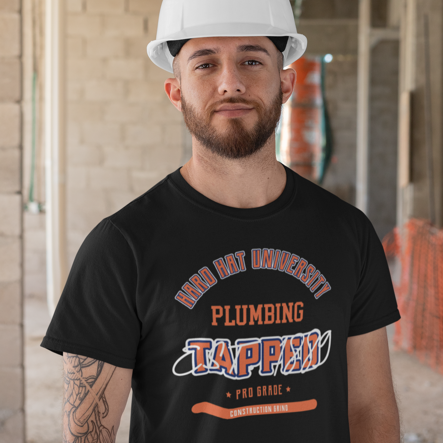 The Construction Grind “Hard Hat University” Plumber's Trade T-Shirt features 'Plumbing – Tapped' in bold college sports style lettering, paying tribute to the skill & professionalism that builds our world. The “Established” date represents the year the trade was formally recognized in the U.S. The 'PRO-GRADE' stamp adds a touch of authenticity and pride. Design is featured on a black Gildan 5000 short-sleeved T-Shirt made with 100% U.S. cotton. Heavy Cotton 5.3 oz/y.